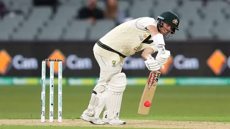 Test batter padding the ball away with bat behind pad during a match