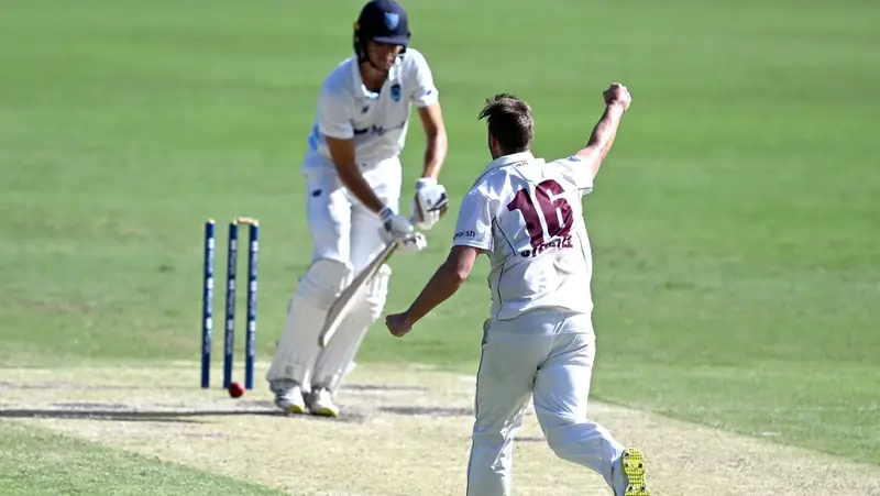 Bowler celebrating after hitting the stumps to get the batter bowled out